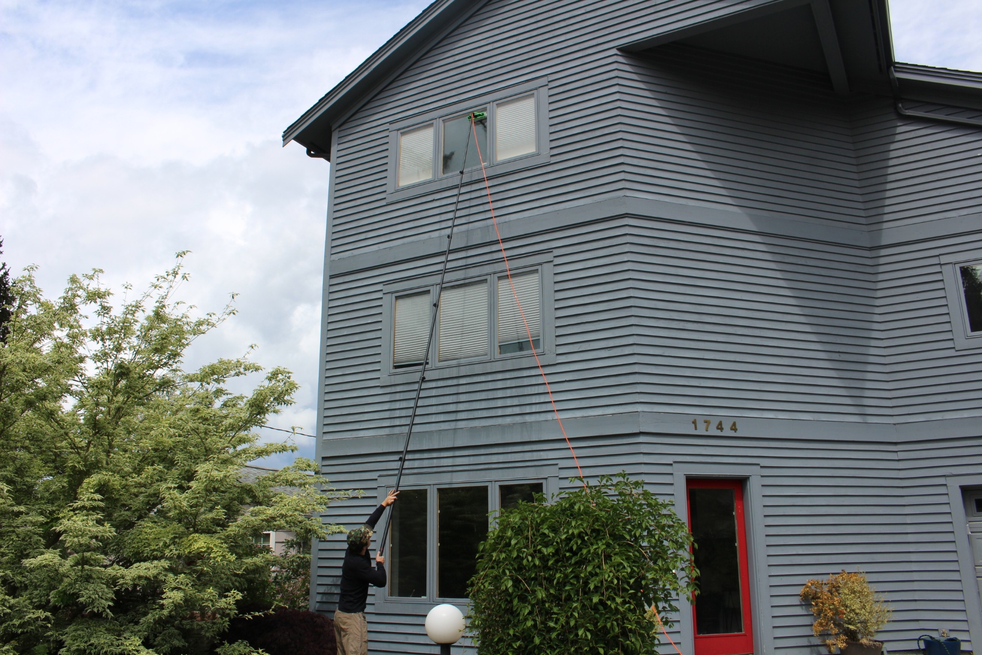 Squeegee cleaning a residential window